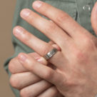 גבר עונד טבעת עם חריטה של תכשיטי גליס